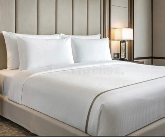 Professional hotel housekeeping services showcasing a spotless, neatly made bed in a luxury hotel room. Ideal for ensuring guest comfort and cleanliness.